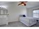 Cozy bedroom with vaulted ceilings, ceiling fan and adjacent vanity with mirror at 10359 W Fair Ave # F, Littleton, CO 80127