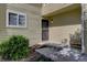 Inviting home entrance with a secure screen door, complemented by neat landscaping and a charming window at 10359 W Fair Ave # F, Littleton, CO 80127