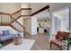Spacious living room with a staircase, wood floors, and a partial view of the kitchen at 10359 W Fair Ave # F, Littleton, CO 80127