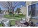 Charming patio with seating area overlooking landscaped community green space, trees, and neighboring homes at 10359 W Fair Ave # F, Littleton, CO 80127