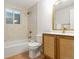 Bathroom with tan tile, modern fixtures, and a wood vanity at 4655 Ludlow St, Boulder, CO 80305