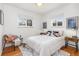 Charming bedroom featuring hardwood floors, a cozy chair, and ample natural light at 4655 Ludlow St, Boulder, CO 80305