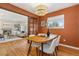 A dining room with an attractive light fixture and open access to a living room with a fireplace at 4655 Ludlow St, Boulder, CO 80305