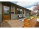 Inviting front porch with seating, a 'Hello' doormat, and a wooden accent wall with plants at 4655 Ludlow St, Boulder, CO 80305