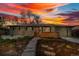 Charming home with landscaped front yard and stone walkway, set against a vibrant sunset sky at 4655 Ludlow St, Boulder, CO 80305