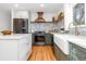 The kitchen showcases stainless steel appliances, light countertops, custom cabinets, and modern finishes at 4655 Ludlow St, Boulder, CO 80305