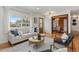 Open-concept living room featuring hardwood floors, comfortable seating, and a dining area in the background at 4655 Ludlow St, Boulder, CO 80305