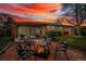 A cozy brick patio at dusk with pergola, fire pit, and comfortable seating invites relaxation at 4655 Ludlow St, Boulder, CO 80305
