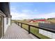 Wooden deck with black rails overlooking the backyard, barn, and countryside at 2190 Helen Ct, Parker, CO 80138