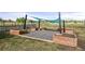 Backyard with wooden planter boxes and a shaded area for gardening or outdoor relaxation at 2190 Helen Ct, Parker, CO 80138