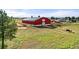 Large red barn with green roof, surrounded by horses and expansive fields at 2190 Helen Ct, Parker, CO 80138