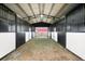 The inside of the barn has horse stalls and overhead lighting for a safe environment at 2190 Helen Ct, Parker, CO 80138