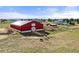 Bright red barn with a white accent, paddocks and horses creates a true country feel at 2190 Helen Ct, Parker, CO 80138