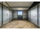 Inside a gray barn showing a empty stall with wooden chip bedding at 2190 Helen Ct, Parker, CO 80138