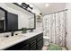 Bathroom featuring modern fixtures, double sinks, birch tree shower curtain and updated lighting at 2190 Helen Ct, Parker, CO 80138