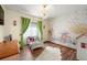 Bedroom with hardwood floors, a colorful wall mural, and an ornate chandelier at 2190 Helen Ct, Parker, CO 80138