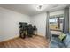 Bright bedroom with wood-look floors, a desk, and large window offering pleasant views at 2190 Helen Ct, Parker, CO 80138