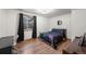 Cozy bedroom with wood-look flooring, dark curtains, and stylish bedding at 2190 Helen Ct, Parker, CO 80138
