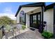 Inviting front porch with black door, potted plants and seating area at 2190 Helen Ct, Parker, CO 80138