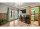 Inviting living area with wood-look flooring, double doors, wood accent wall and beverage center at 2190 Helen Ct, Parker, CO 80138