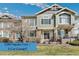 Charming townhome featuring a combination of stone and siding, coupled with a well-maintained lawn and patio, offering great curb appeal at 15064 E Crestridge Dr, Centennial, CO 80015