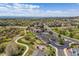 Stunning aerial view of community pool, clubhouse, and surrounding neighborhood with mountain views at 23110 York Ave, Parker, CO 80138