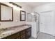 Bathroom features double sinks, granite countertops, and glass shower with neutral color scheme at 23110 York Ave, Parker, CO 80138