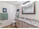 Bright bathroom with a vanity, granite countertops, and decorative wall art at 23110 York Ave, Parker, CO 80138