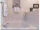 Bright bathroom boasts a relaxing soaking tub with tiled surround and decorative wall art at 23110 York Ave, Parker, CO 80138
