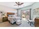 Bright bedroom features stylish decor, a ceiling fan, and sliding glass door to the exterior at 23110 York Ave, Parker, CO 80138