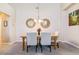 Bright dining area boasts modern mirrors, stylish chairs, and a wooden table at 23110 York Ave, Parker, CO 80138