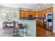 Modern kitchen featuring wood cabinets, stainless steel appliances, and a bar area at 23110 York Ave, Parker, CO 80138