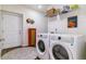 Functional laundry room features modern washer and dryer with ample storage and decor at 23110 York Ave, Parker, CO 80138
