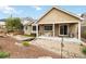 Inviting backyard with a covered patio, decorative stream, solar panels, and artificial turf area at 2724 Rising Moon Way, Castle Rock, CO 80109