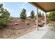 Picturesque backyard featuring natural landscaping, wooden fencing, and an inviting outdoor sitting area at 2724 Rising Moon Way, Castle Rock, CO 80109
