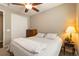 Comfortable bedroom features a ceiling fan, closet, and cozy bed with decorative lamp at 2724 Rising Moon Way, Castle Rock, CO 80109