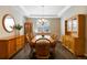 Dining room featuring hardwood floors, decorative mirror, chandelier, and a window at 2724 Rising Moon Way, Castle Rock, CO 80109