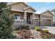 Well-maintained home with an inviting front porch, two-car garage, and front yard landscaping at 2724 Rising Moon Way, Castle Rock, CO 80109