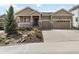 Charming home featuring a two-car garage, landscaped yard, and inviting front porch at 2724 Rising Moon Way, Castle Rock, CO 80109