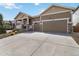 Inviting home featuring a two-car garage, attractive yard, and comfortable front porch at 2724 Rising Moon Way, Castle Rock, CO 80109