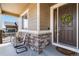 Cozy front porch with decorative wreath, seating, and stone detailing on the house's facade at 2724 Rising Moon Way, Castle Rock, CO 80109