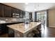 Modern kitchen featuring dark cabinets, granite counters, tile backsplash, and stainless steel appliances at 2724 Rising Moon Way, Castle Rock, CO 80109