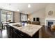 Bright kitchen featuring granite countertops, a kitchen island, and an open floorplan at 2724 Rising Moon Way, Castle Rock, CO 80109