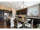 Open kitchen with island, granite countertops, dark cabinets, and stainless steel appliances at 2724 Rising Moon Way, Castle Rock, CO 80109