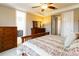 The main bedroom offers access to the ensuite bathroom and features a ceiling fan at 2724 Rising Moon Way, Castle Rock, CO 80109