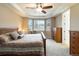 Spacious main bedroom boasts tray ceilings, a ceiling fan, and natural light from large windows at 2724 Rising Moon Way, Castle Rock, CO 80109
