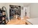 Bright bedroom with hardwood floors, a large closet, and a glimpse into the hallway, maximizing space at 6213 Willow Ln, Boulder, CO 80301