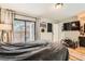 Bedroom featuring wood floors, a sliding door with outdoor access, and lots of natural light at 6213 Willow Ln, Boulder, CO 80301