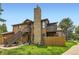 An exterior view of a brown home with a stone chimney and stairs at 6213 Willow Ln, Boulder, CO 80301