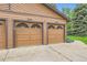 A two car garage with a driveway and green space at 6213 Willow Ln, Boulder, CO 80301